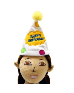 Close-up of a plush birthday hat with a yellow pom-pom, multicolored embroidered dots, and a bright yellow happy birthday patch.